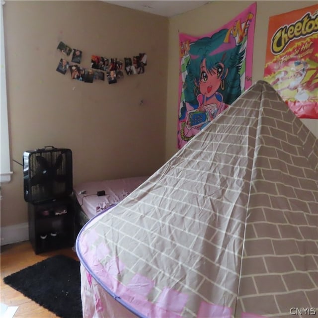 bedroom with wood-type flooring