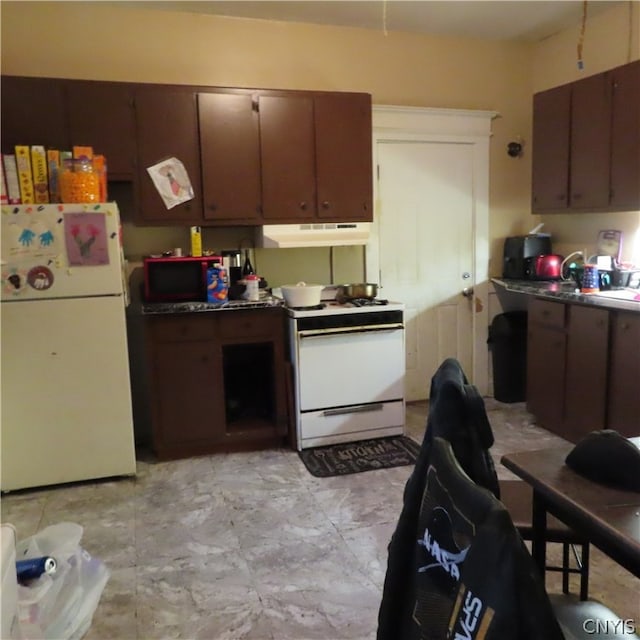 kitchen with white appliances, dark brown cabinets, and light tile floors