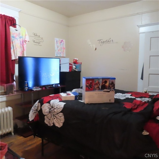 bedroom featuring dark wood-type flooring and radiator