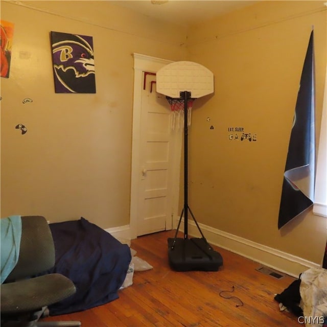 exercise room with dark hardwood / wood-style floors