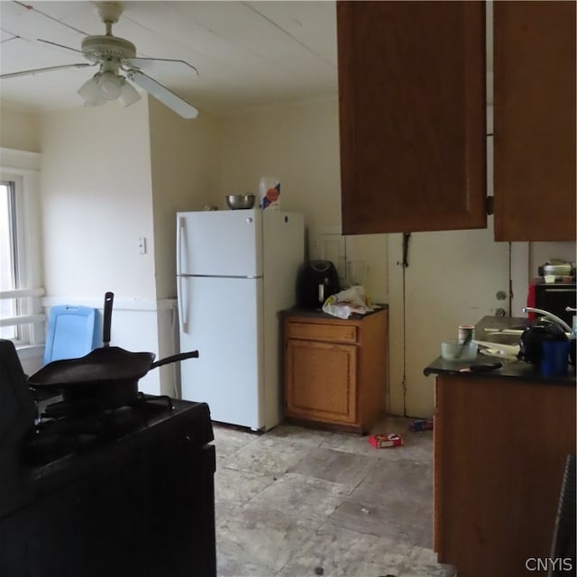 kitchen featuring ceiling fan, light tile flooring, and white refrigerator