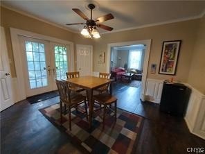 dining space with dark hardwood / wood-style flooring, ceiling fan, crown molding, and french doors