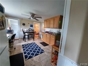 kitchen featuring light tile floors and ceiling fan