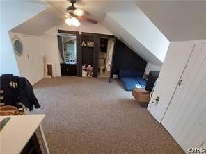 additional living space with ceiling fan, light carpet, and vaulted ceiling