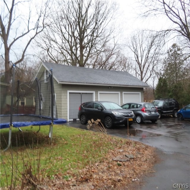 exterior space featuring a trampoline and a garage