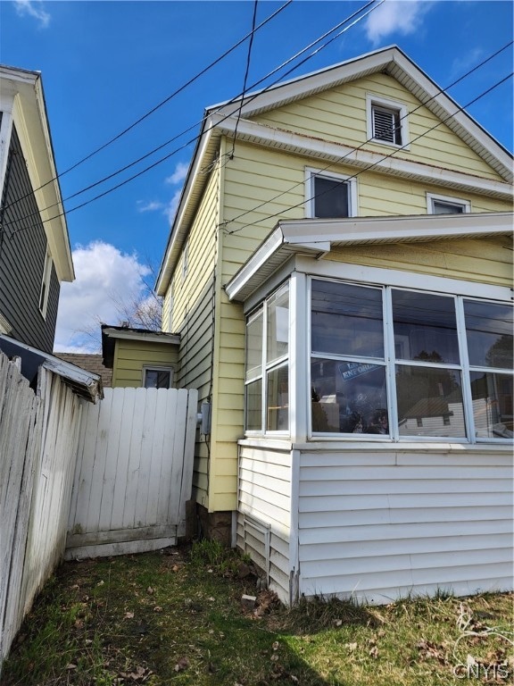 view of property exterior featuring a sunroom