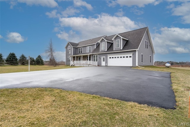 view of front of home with a front lawn and a garage