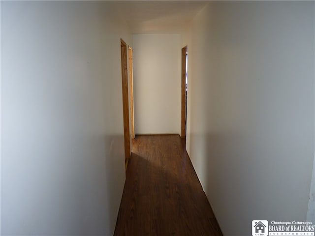 hall with dark wood-type flooring