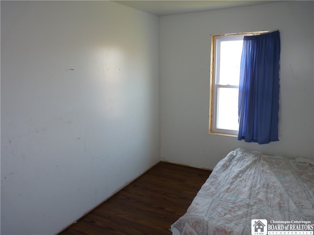 unfurnished bedroom with dark hardwood / wood-style flooring