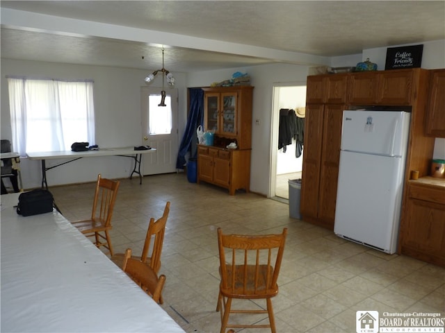 dining space featuring an inviting chandelier and light tile floors