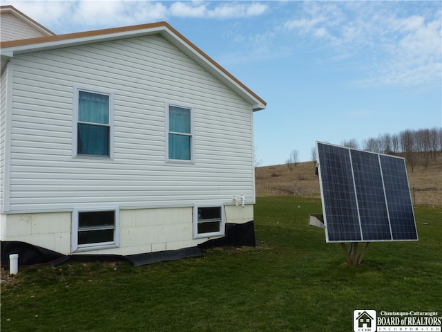 view of property exterior featuring a yard and solar panels