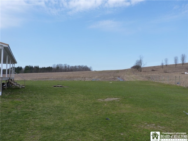 view of yard with a rural view