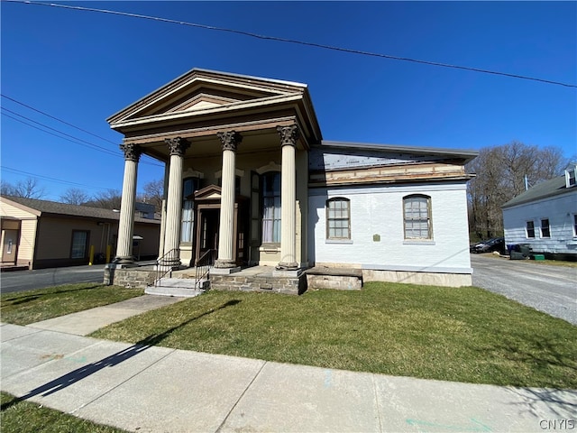 greek revival house with a front lawn