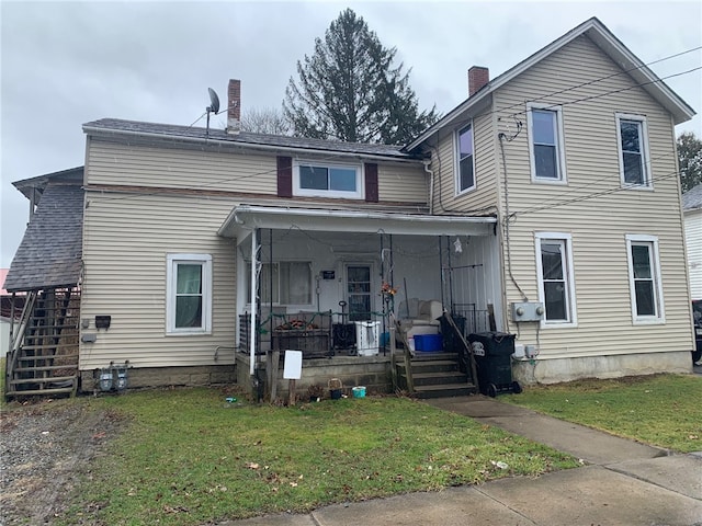 view of front of property with covered porch and a front yard