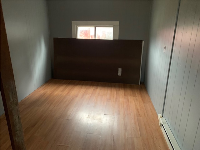 spare room with light hardwood / wood-style flooring and a baseboard heating unit