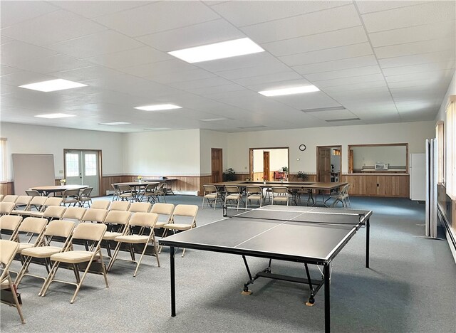 recreation room featuring a paneled ceiling