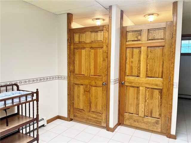 bathroom featuring baseboard heating and tile floors