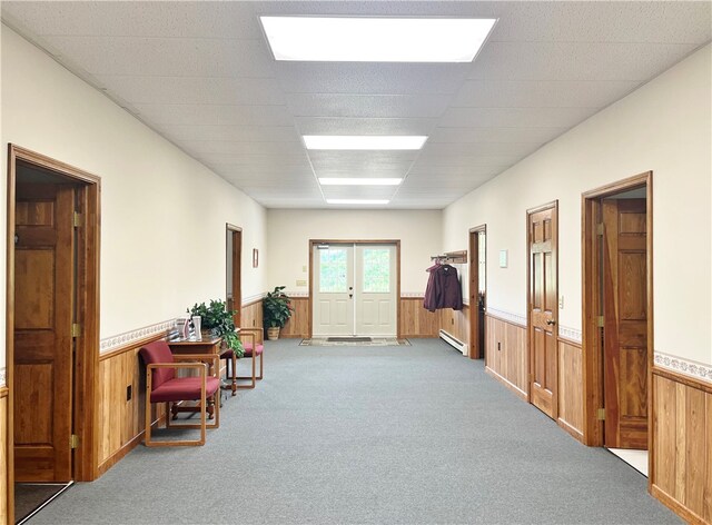 interior space featuring a baseboard radiator and light carpet