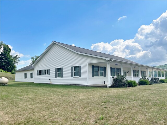 back of house featuring a yard and a porch