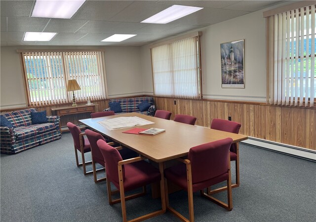 carpeted dining room featuring a drop ceiling