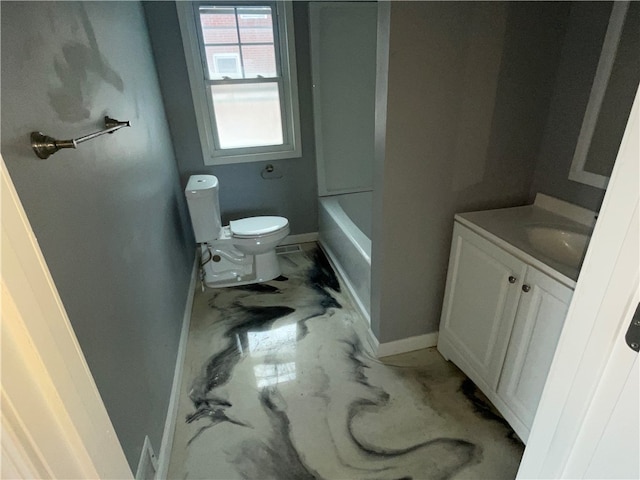 bathroom with vanity, a bath, and toilet