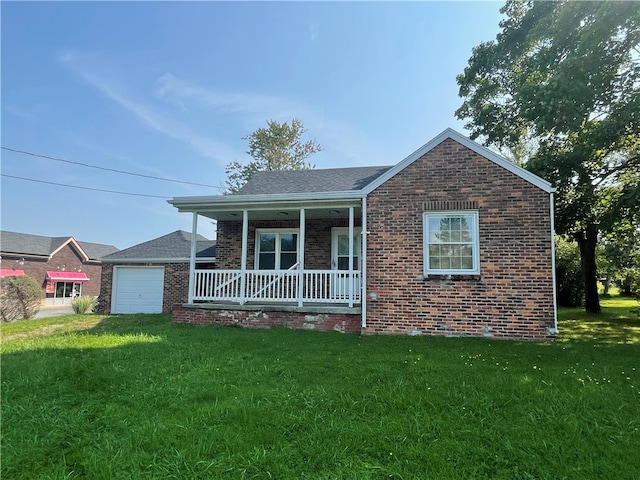 view of front of property with a garage, a porch, and a front yard