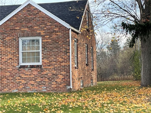 2125 Transit Rd, Elma, NY 14059 - view of side of home featuring brick siding, roof with shingles, and a yard