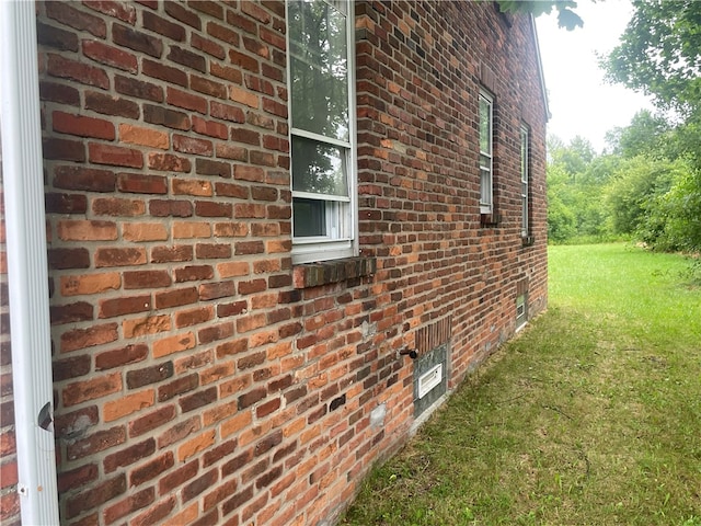 view of property exterior with a lawn