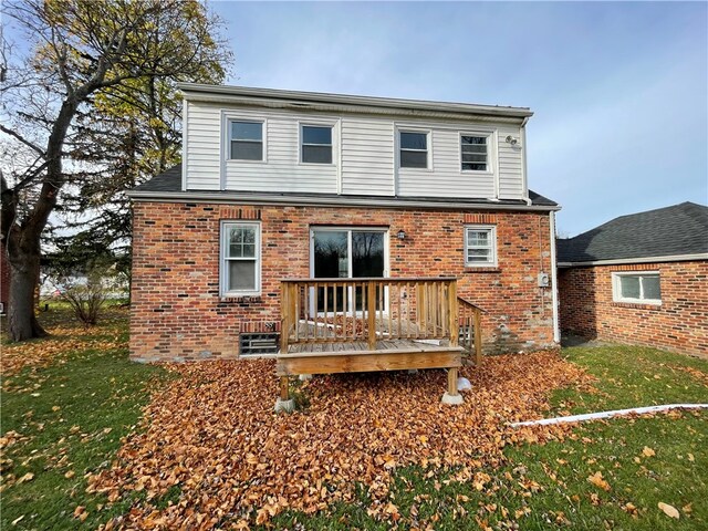 back of house with a deck and a lawn