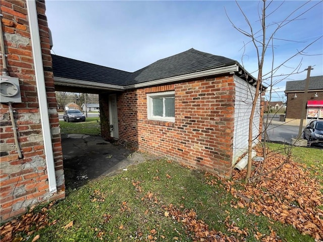 2125 Transit Rd, Elma, NY 14059 - view of property exterior with a shingled roof, a carport, and brick siding