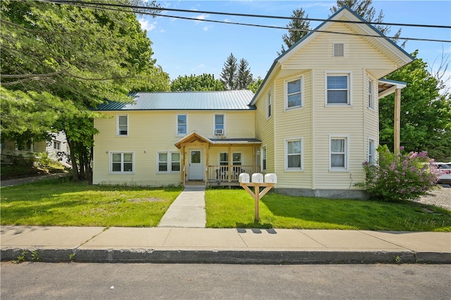 view of front of home featuring a front lawn and a porch