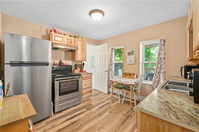 kitchen featuring light brown cabinetry, light hardwood / wood-style floors, appliances with stainless steel finishes, and sink