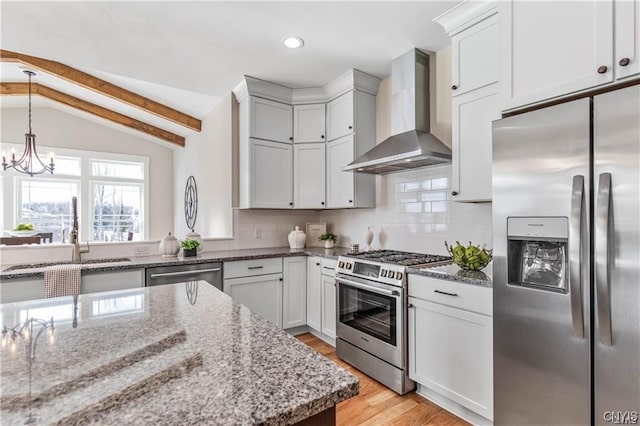 kitchen with white cabinetry, wall chimney range hood, stainless steel appliances, tasteful backsplash, and lofted ceiling with beams