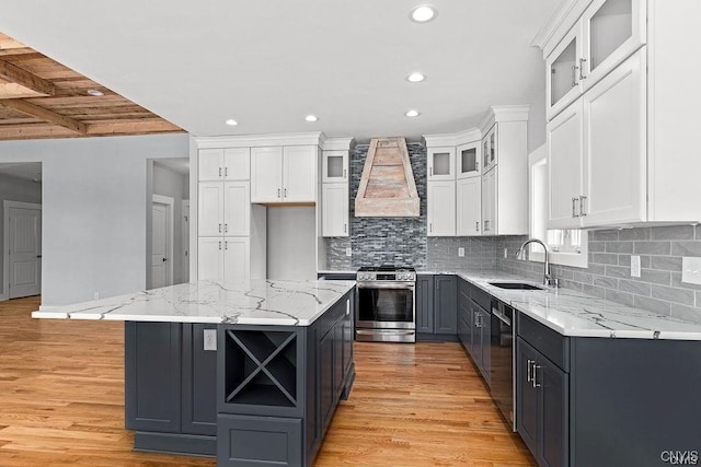 kitchen featuring premium range hood, white cabinetry, a center island, and stainless steel appliances