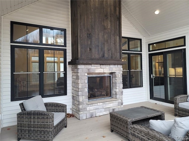 wooden terrace with a stone fireplace