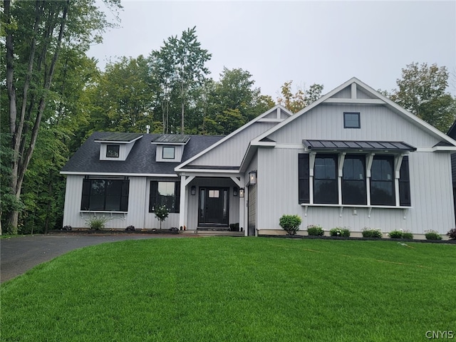 modern farmhouse style home with a front yard