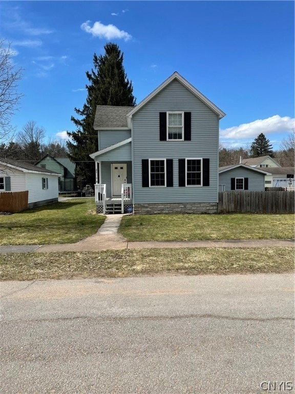 front of property featuring a front lawn and covered porch