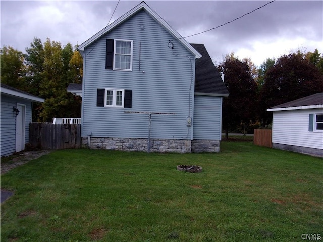 rear view of property featuring a yard