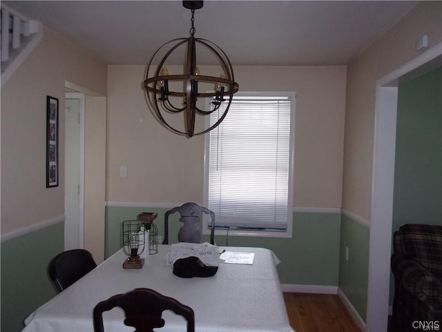 dining area featuring a notable chandelier and dark hardwood / wood-style floors