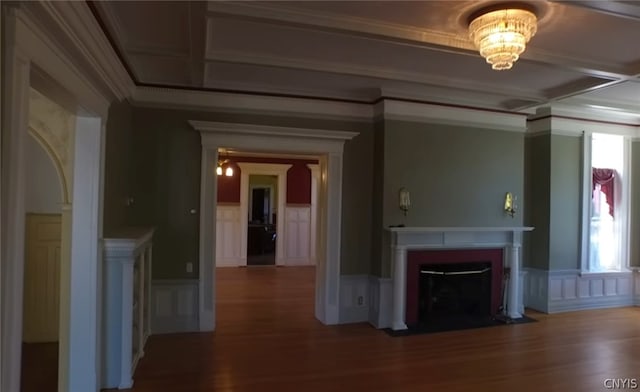 unfurnished living room featuring ornamental molding and dark hardwood / wood-style flooring