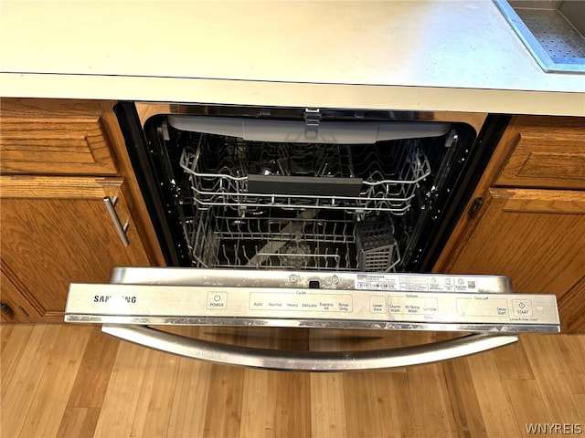 room details featuring wood-type flooring and dishwasher