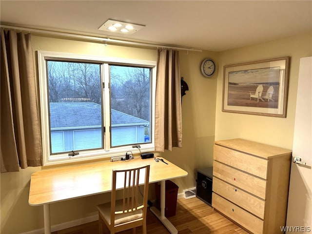 dining area featuring hardwood / wood-style floors and plenty of natural light