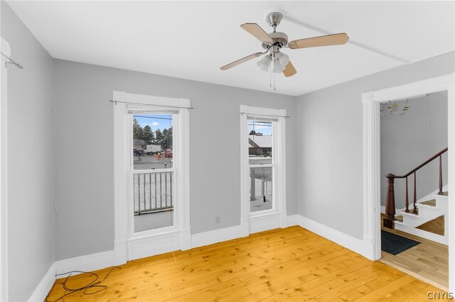 spare room with light hardwood / wood-style flooring and ceiling fan