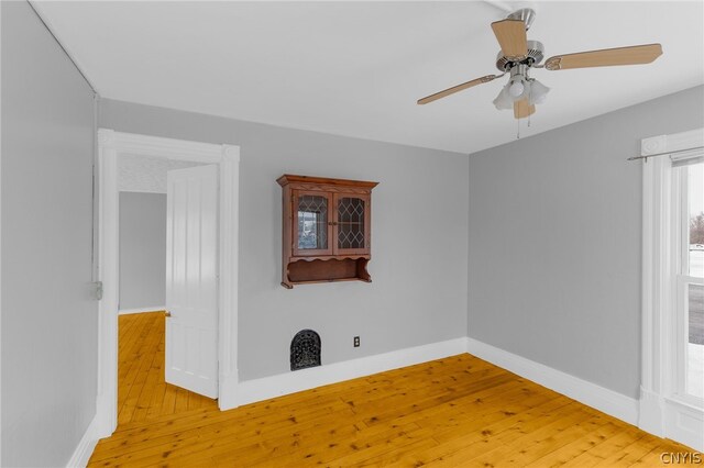 unfurnished room with light hardwood / wood-style flooring and ceiling fan