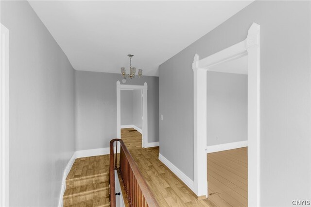 interior space with wood-type flooring and a chandelier