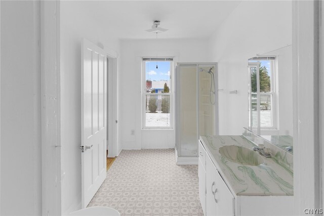 bathroom with tile patterned floors, vanity, and an enclosed shower