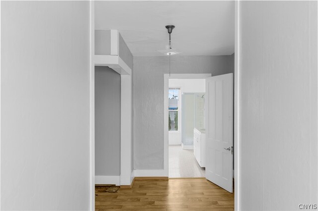 corridor with light hardwood / wood-style flooring