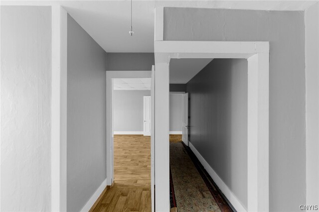 corridor with hardwood / wood-style floors