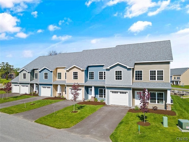 view of property with a front lawn and a garage