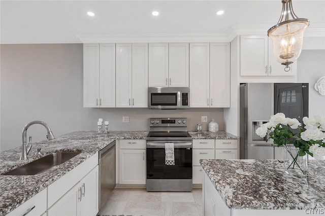 kitchen featuring appliances with stainless steel finishes, light tile flooring, sink, stone countertops, and white cabinets